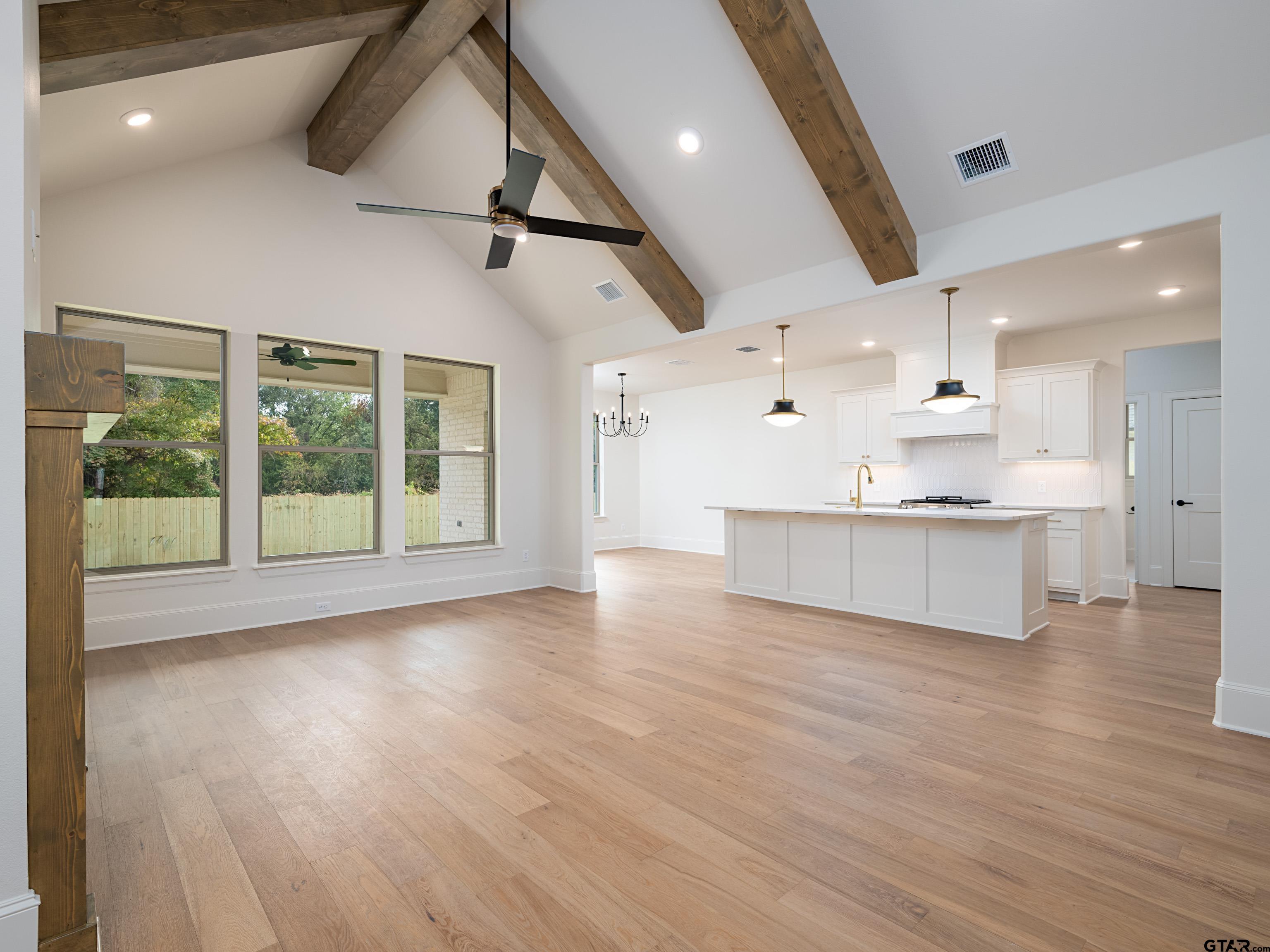 5216 Hollytree Drive Tyler, TX 75703 - Photo 5 of 28 a view of an empty room with a window and wooden floor