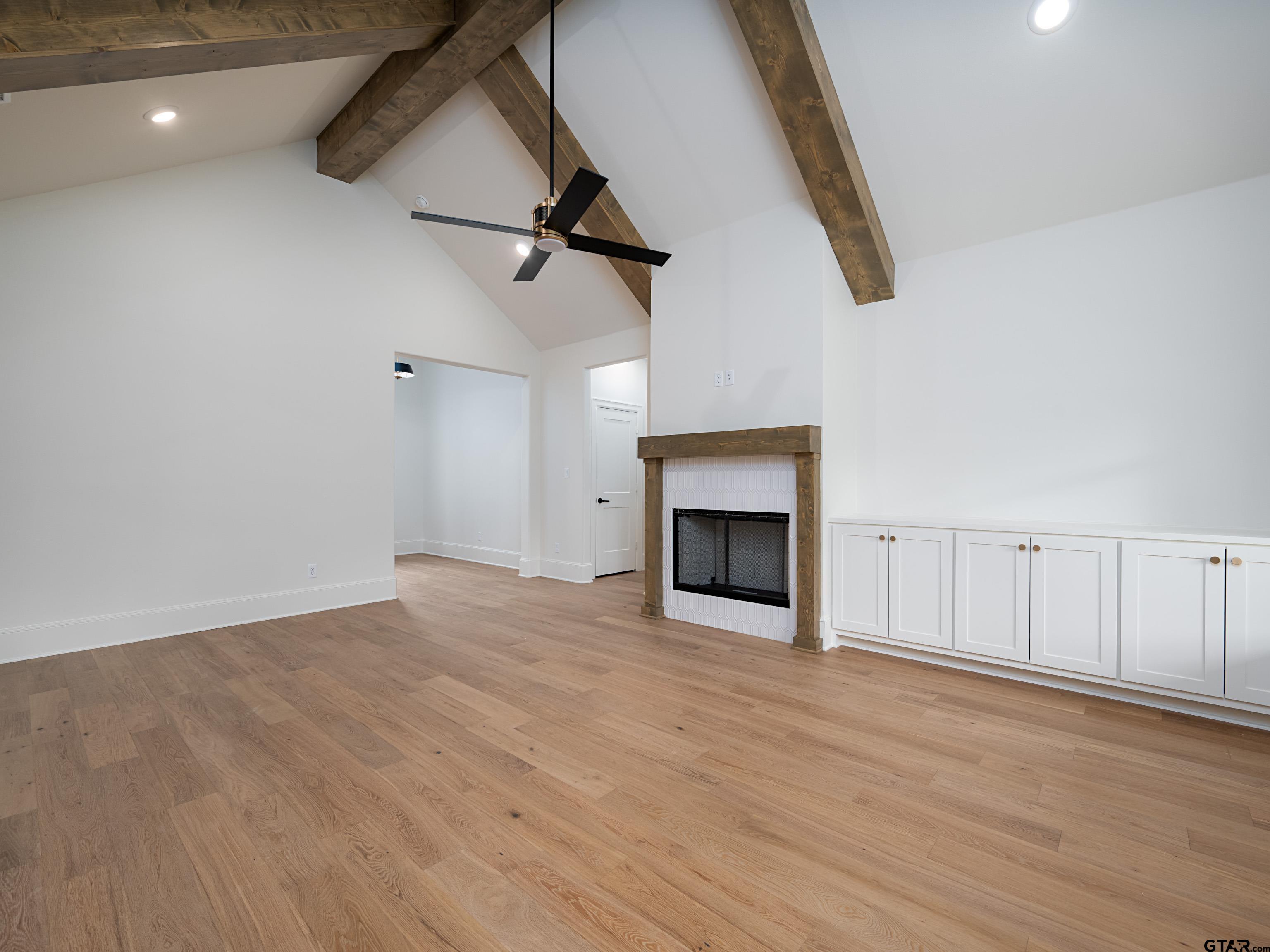 5216 Hollytree Drive Tyler, TX 75703 - Photo 7 of 28 a view of empty room with wooden floor and fireplace