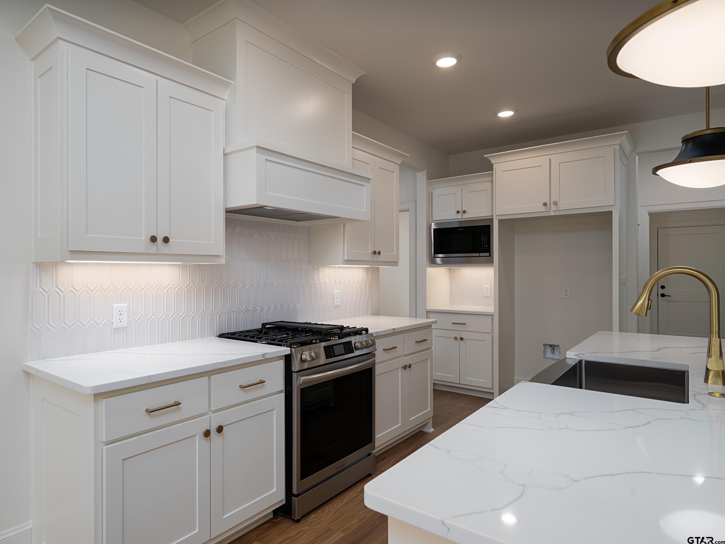 5216 Hollytree Drive Tyler, TX 75703 - Photo 9 of 28 a kitchen with a sink appliances and cabinets