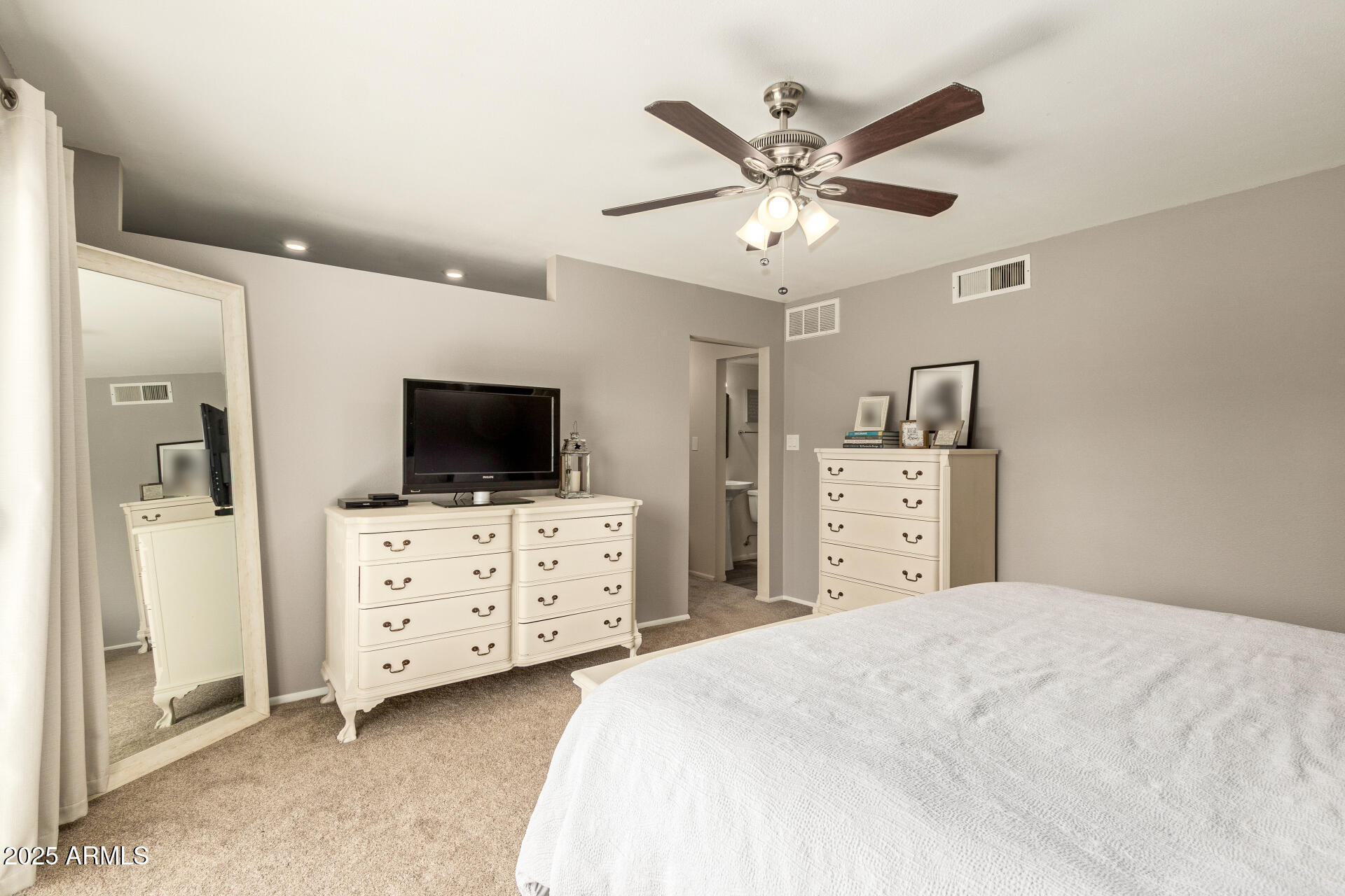 8135 North Central Avenue, Unit 7 Phoenix, AZ 85020 - Photo 11 of 25 a bedroom with a large bed and a flat screen tv