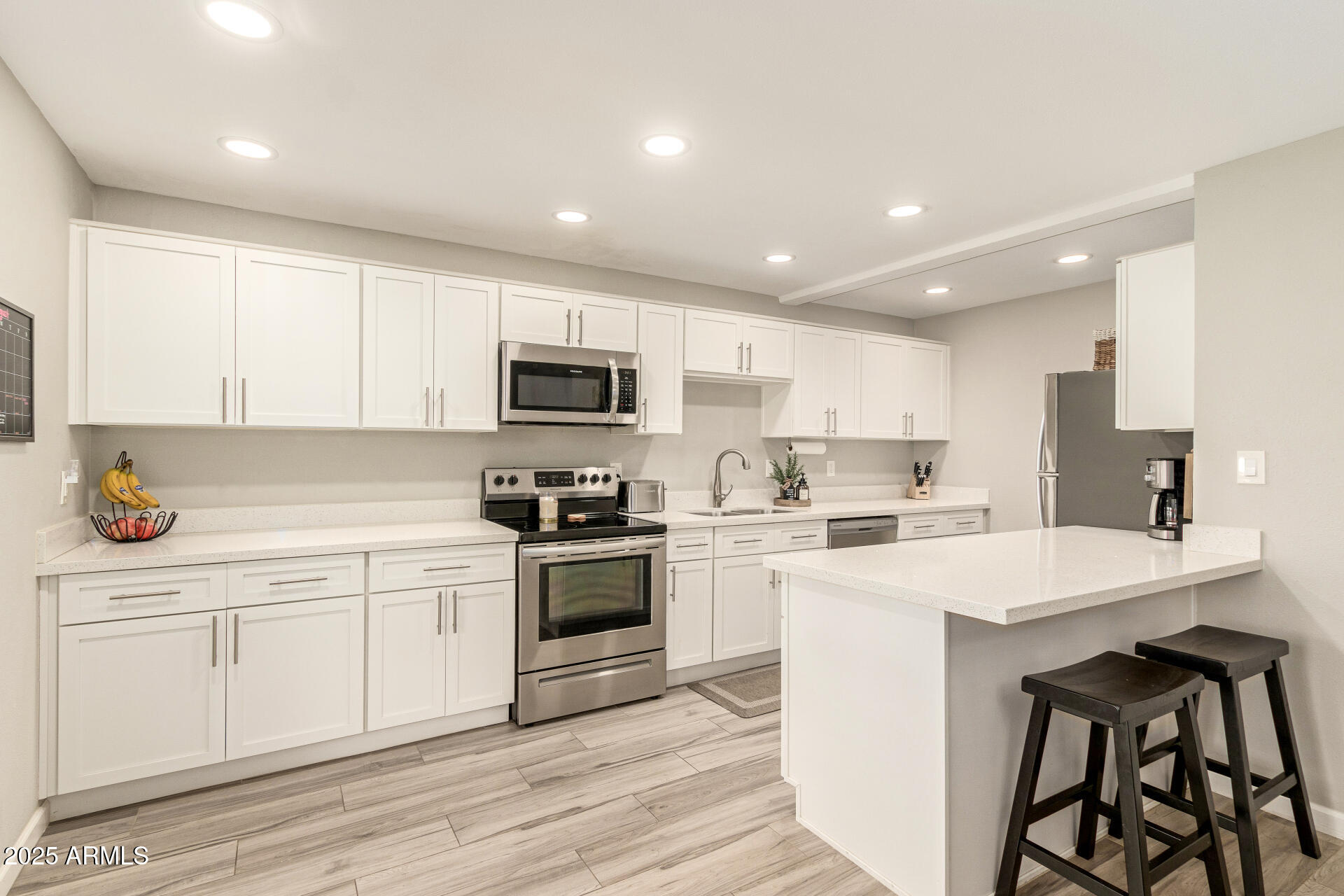 8135 North Central Avenue, Unit 7 Phoenix, AZ 85020 - Photo 5 of 25 a kitchen with a sink white cabinets and stainless steel appliances