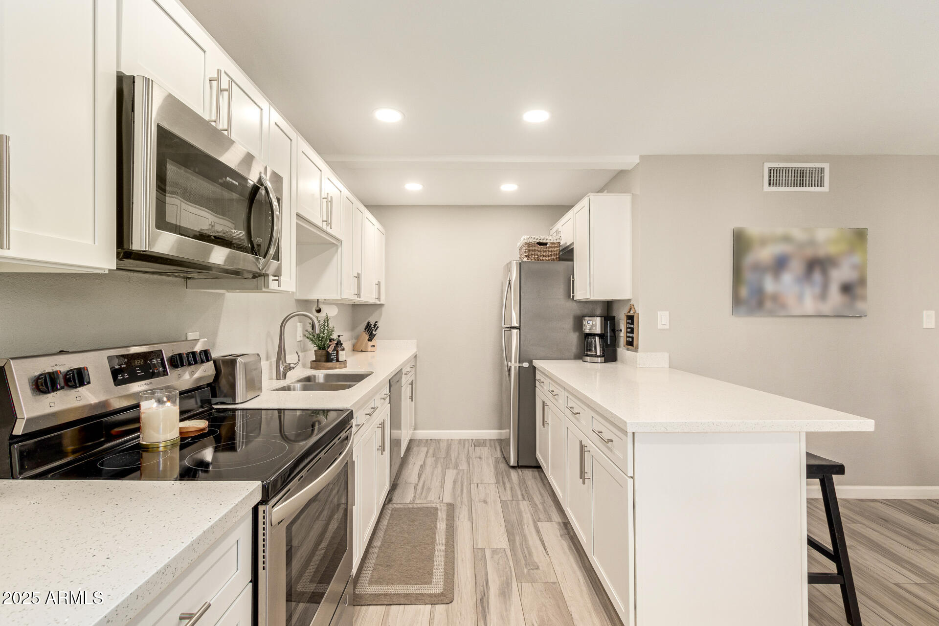8135 North Central Avenue, Unit 7 Phoenix, AZ 85020 - Photo 6 of 25 a kitchen with stainless steel appliances a stove a sink a microwave a refrigerator and cabinets