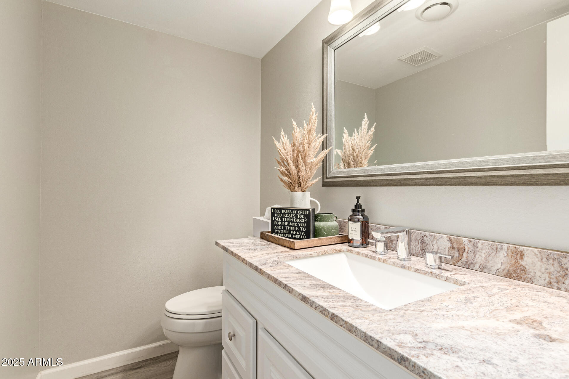 8135 North Central Avenue, Unit 7 Phoenix, AZ 85020 - Photo 9 of 25 a bathroom with a granite countertop sink a toilet and a mirror