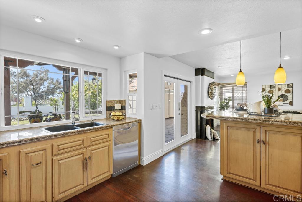 978 Roca Place Chula Vista, CA 91910 - Photo 15 of 45 a kitchen with stainless steel appliances granite countertop a stove a sink a center island and a window