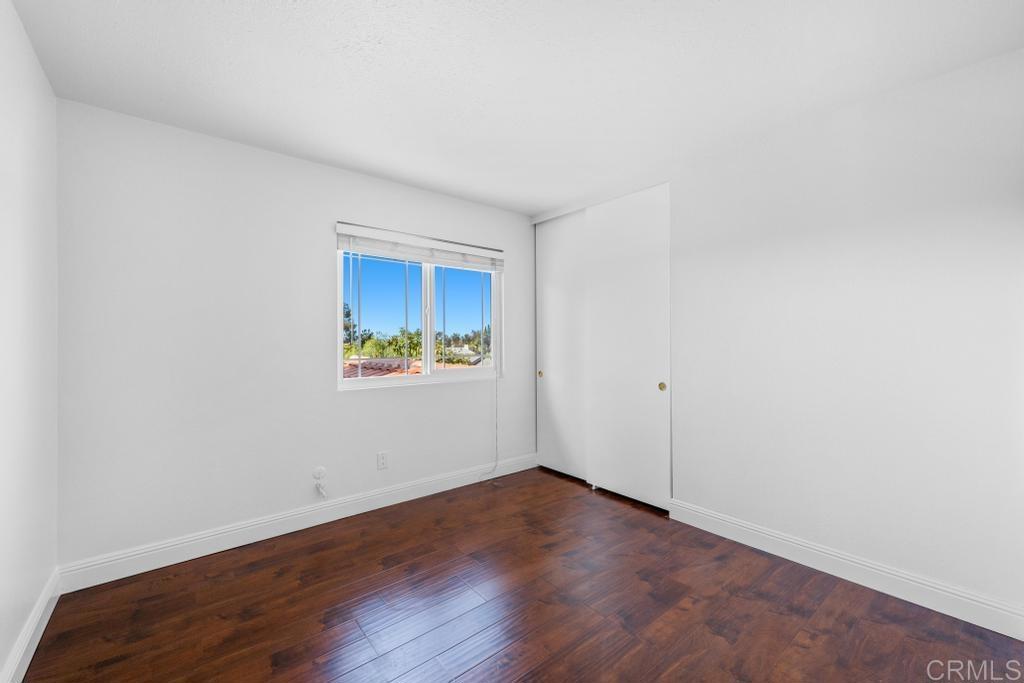 978 Roca Place Chula Vista, CA 91910 - Photo 32 of 45 an empty room with wooden floor and windows