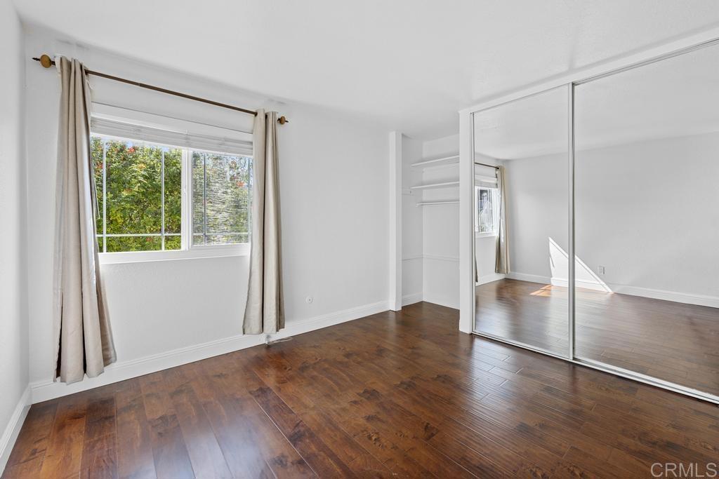 978 Roca Place Chula Vista, CA 91910 - Photo 34 of 45 an empty room with wooden floor and windows