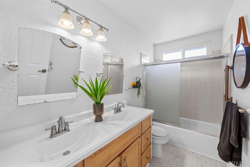 978 Roca Place Chula Vista, CA 91910 - Photo 35 of 45 a bathroom with a sink a toilet and a mirror