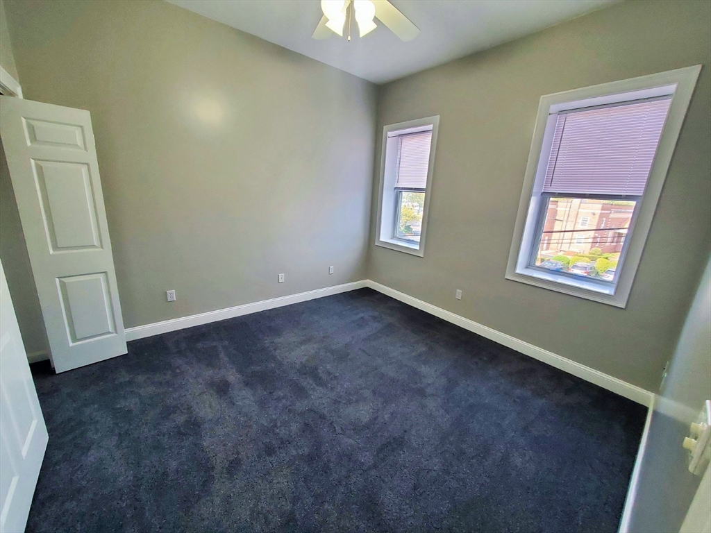 37 Central Square, Unit 37B Bridgewater, MA 02324 - Photo 5 of 15 an empty room with windows and closet