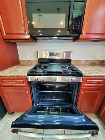 a stove top oven sitting inside of a kitchen