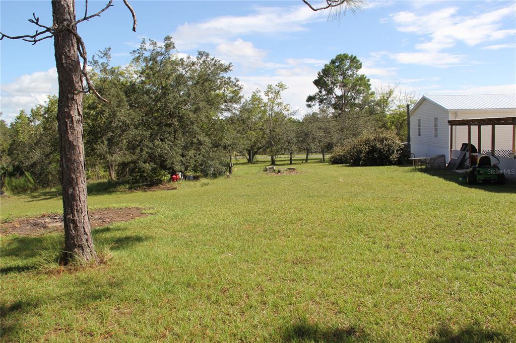 13127 Star Road Brooksville, FL 34613 - Photo 51 of 54 a view of a house with yard and basketball court
