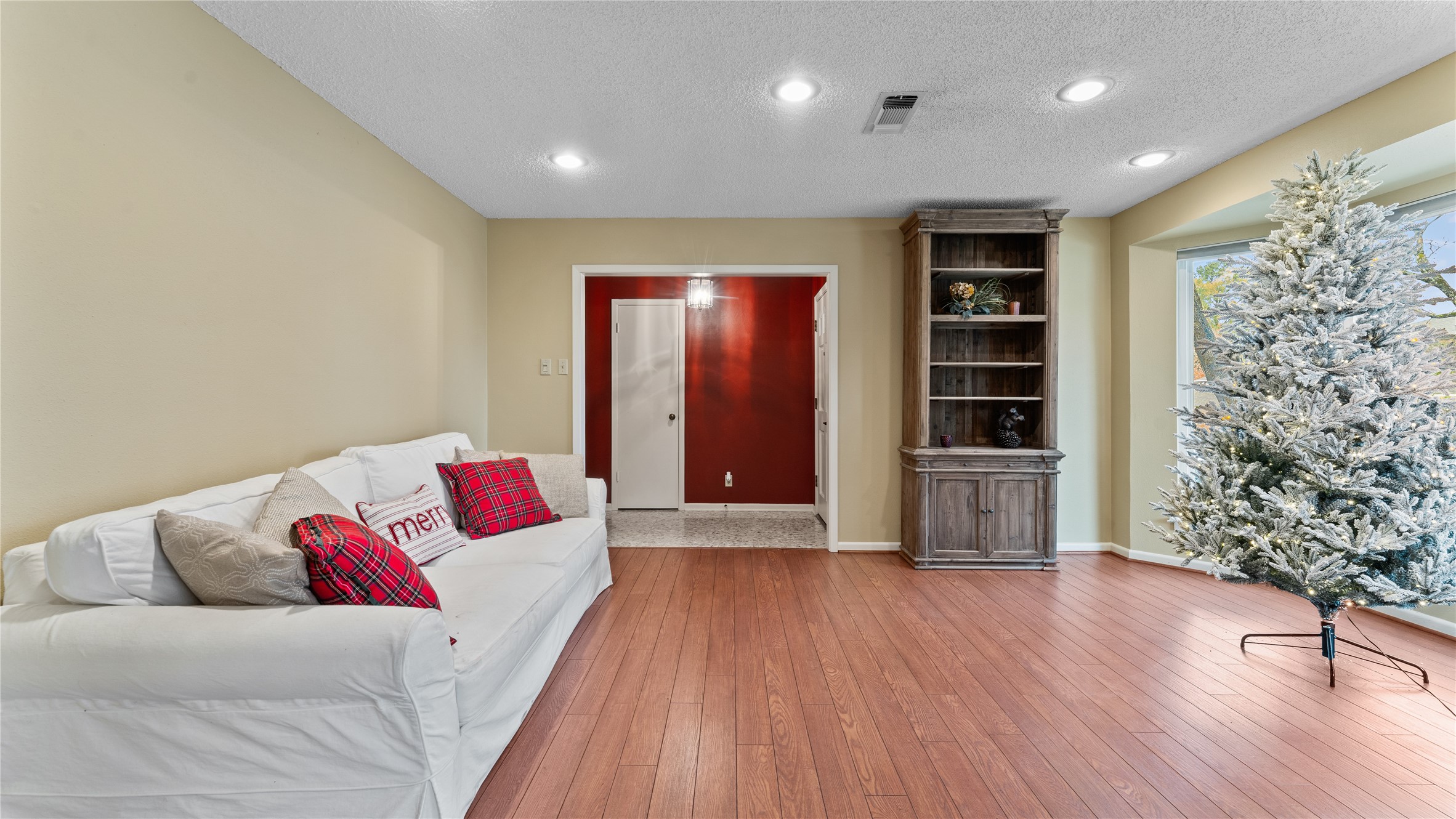 208 Magnolia Way Huntsville, TX 77320 - Photo 6 of 26 This cozy room features warm white oak wood flooring, and a large window that brings in natural light.