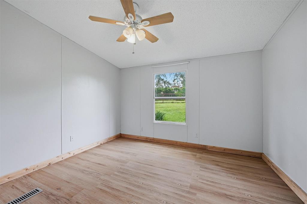 150 Gilbreath Road Sadler, TX 76264 - Photo 18 of 34 wooden floor in an empty room with a window