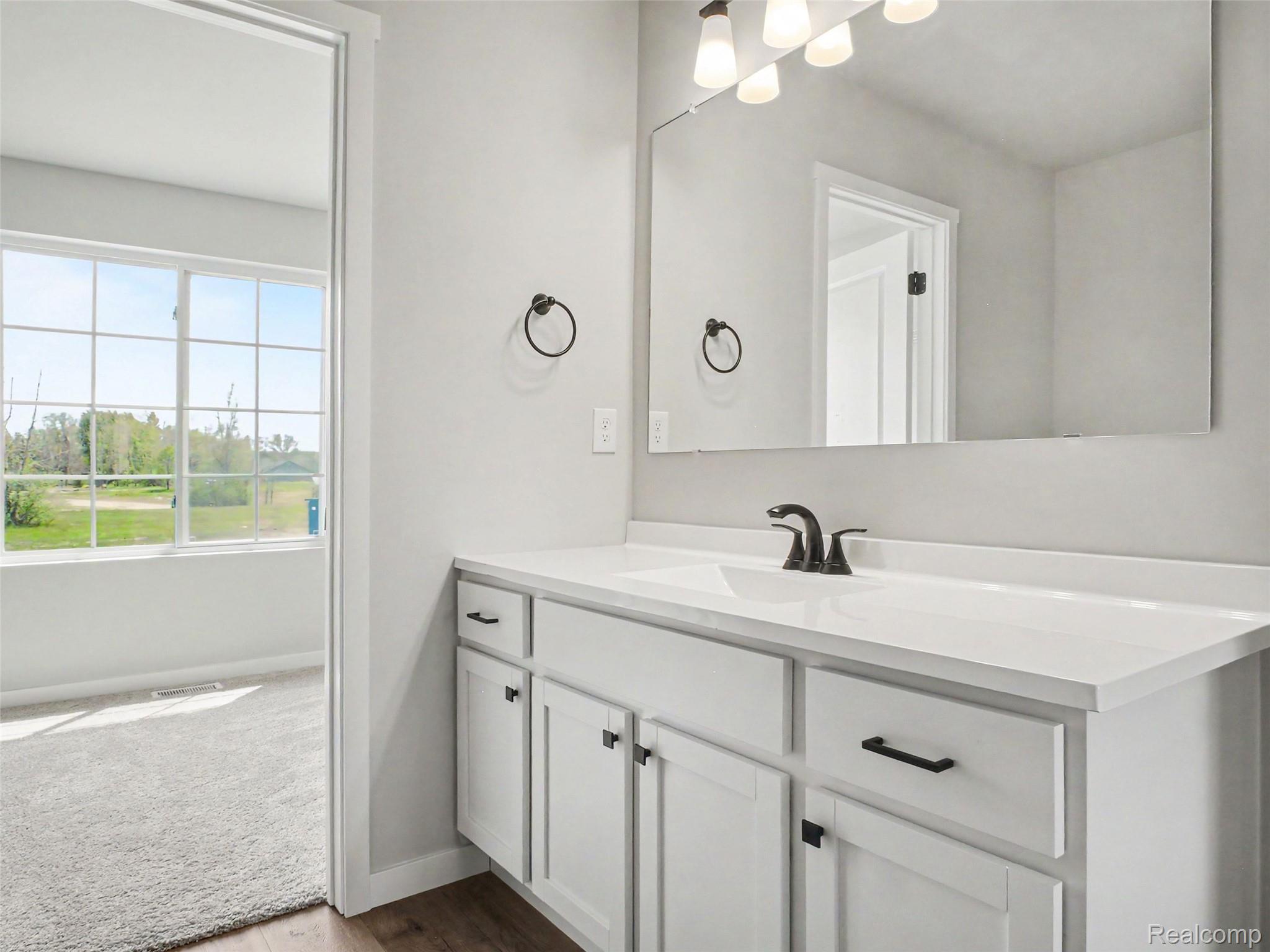 3166 Quail Ridge Court Clio, MI 48420 - Photo 7 of 23 The primary suite is located on the upper level and includes a private bath and oversized walk-in closet with large window for natural lighting.