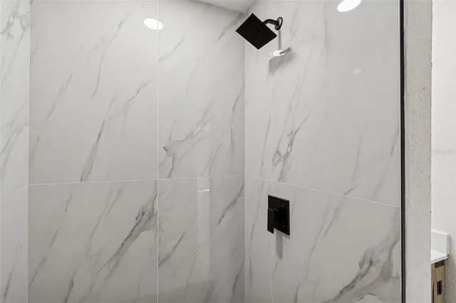 a bathroom with a bathtub and a shower