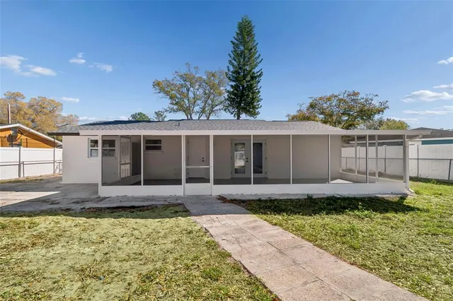 an aerial view of a house with swimming pool and porch