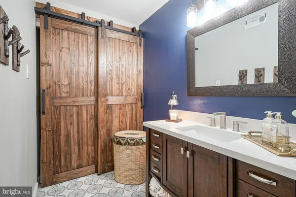 a bathroom with a sink a mirror and a shower