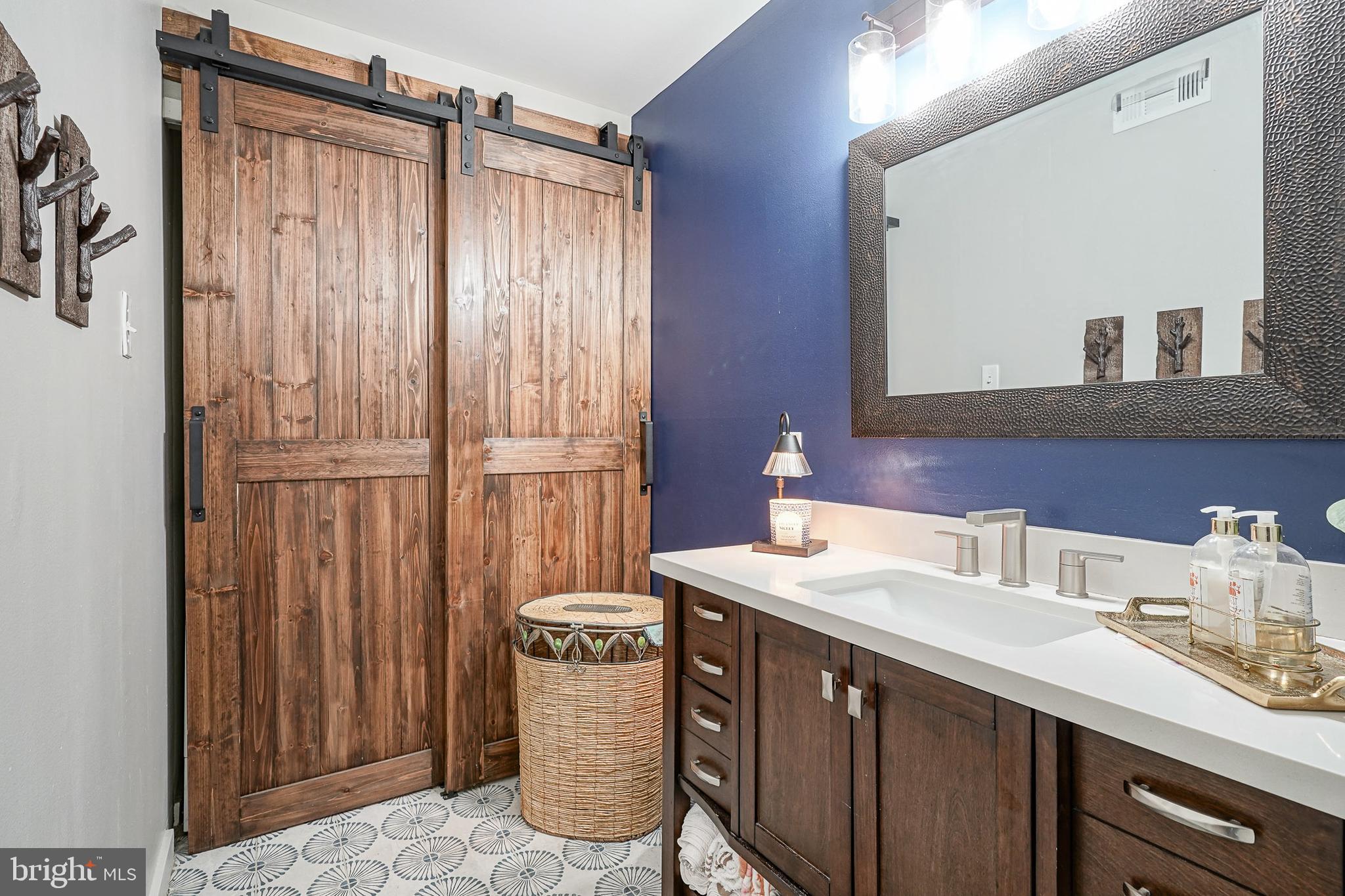 2305 Sandra Road Voorhees, NJ 08043 - Photo 13 of 24 a bathroom with a sink a mirror and a shower