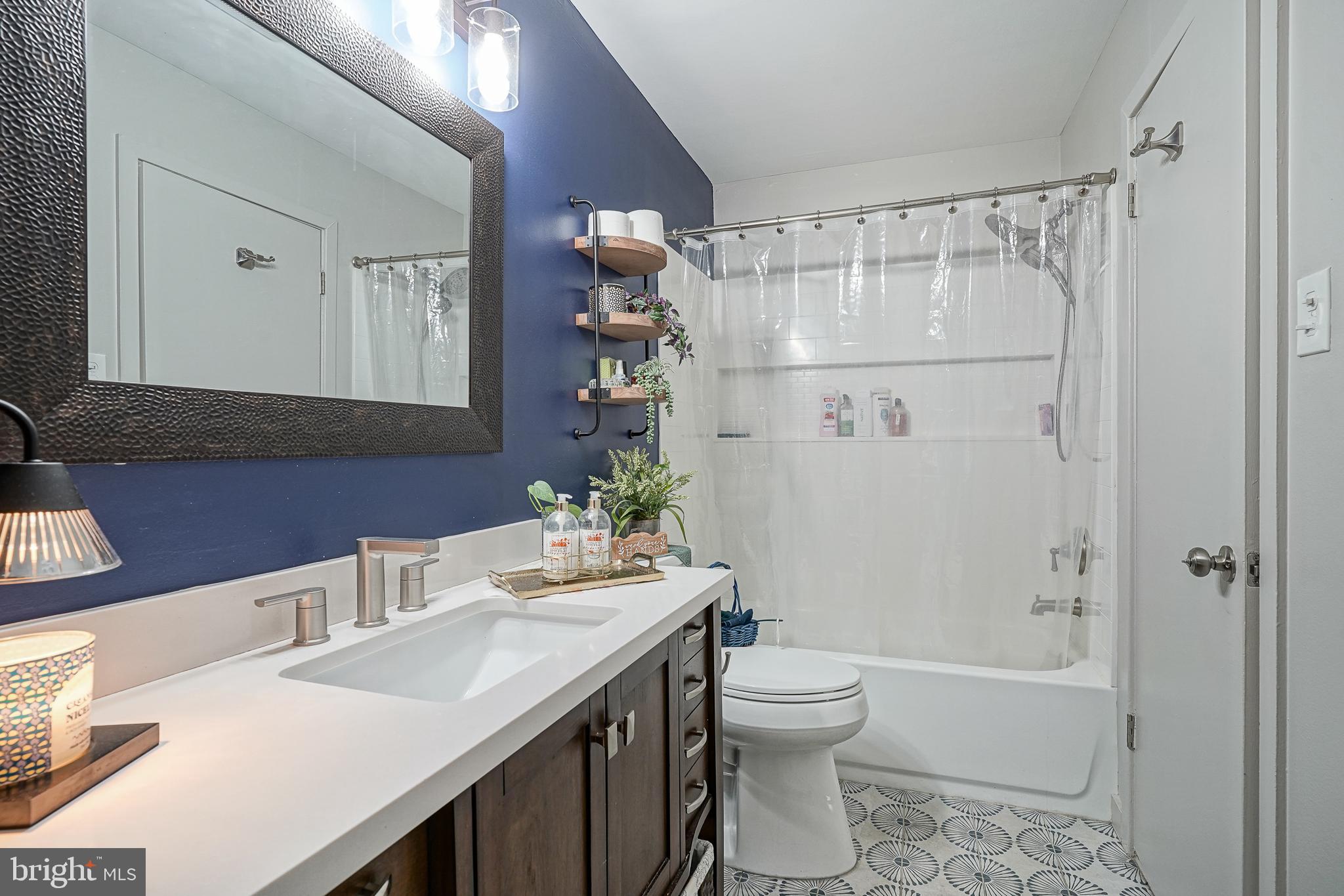 2305 Sandra Road Voorhees, NJ 08043 - Photo 15 of 24 a bathroom with a sink a toilet and shower