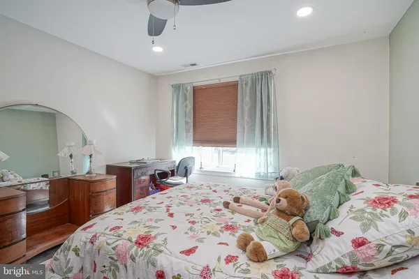 a bedroom with a bed and a dresser