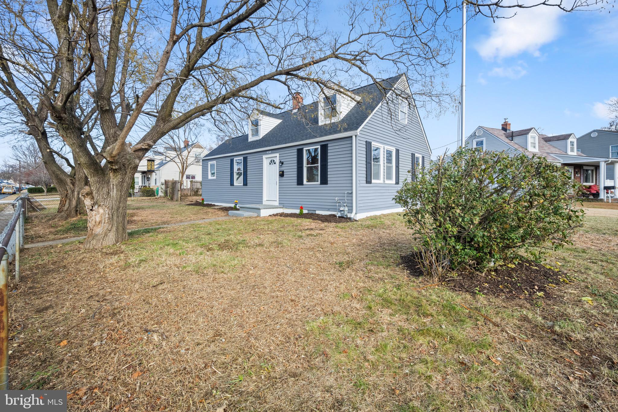 a house that has a tree in front of it