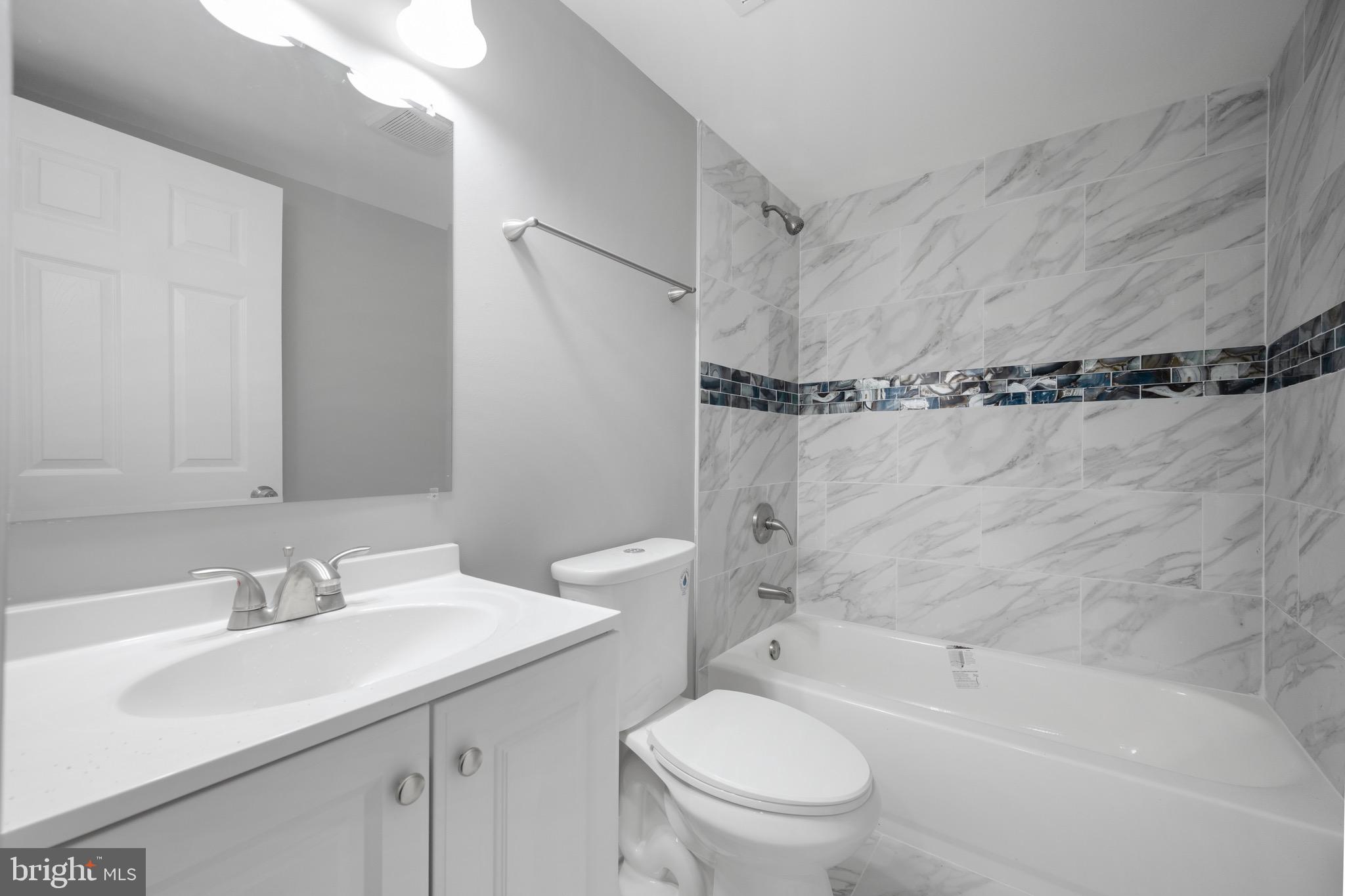 3401 Court Way Baltimore, MD 21222 - Photo 14 of 35 a bathroom with a sink toilet vanity and shower