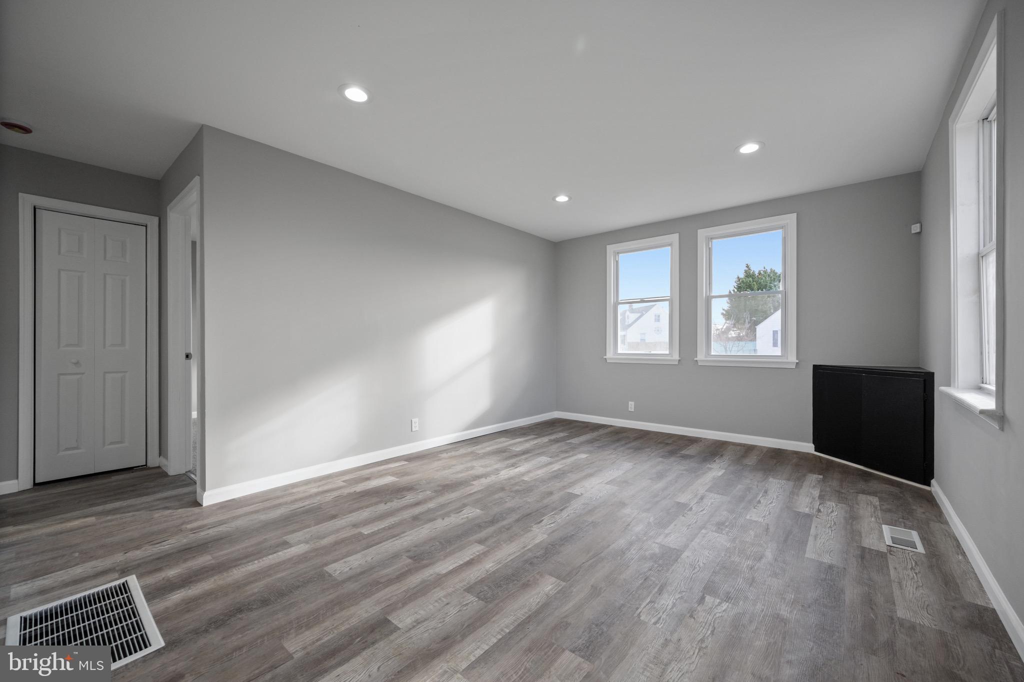 3401 Court Way Baltimore, MD 21222 - Photo 25 of 35 an empty room with wooden floor and windows