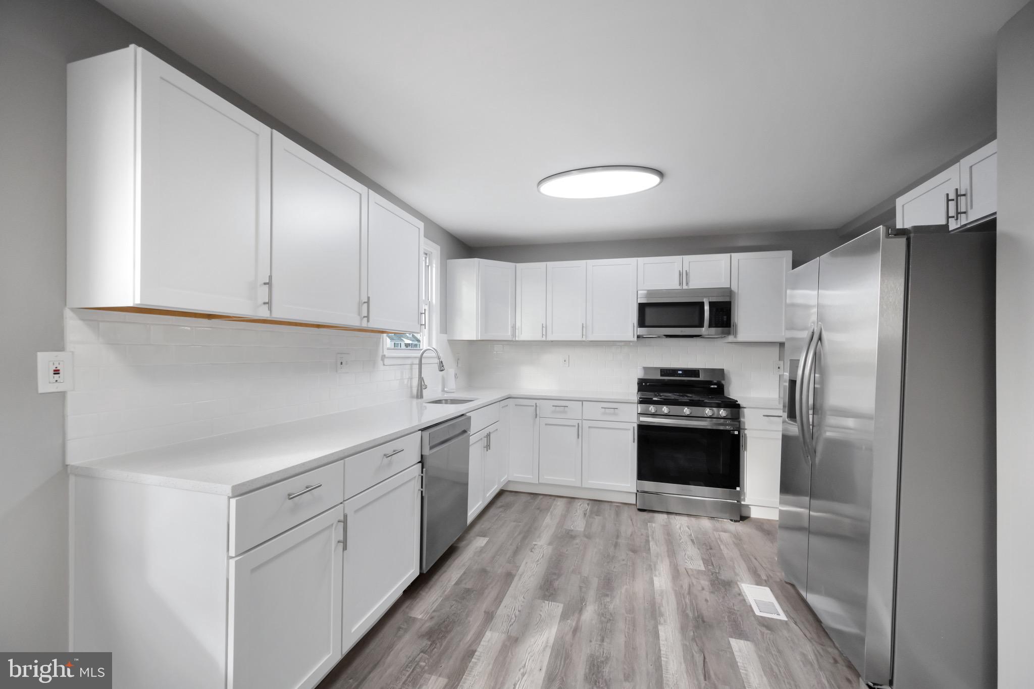 3401 Court Way Baltimore, MD 21222 - Photo 30 of 35 a kitchen with stainless steel appliances a refrigerator stove and sink