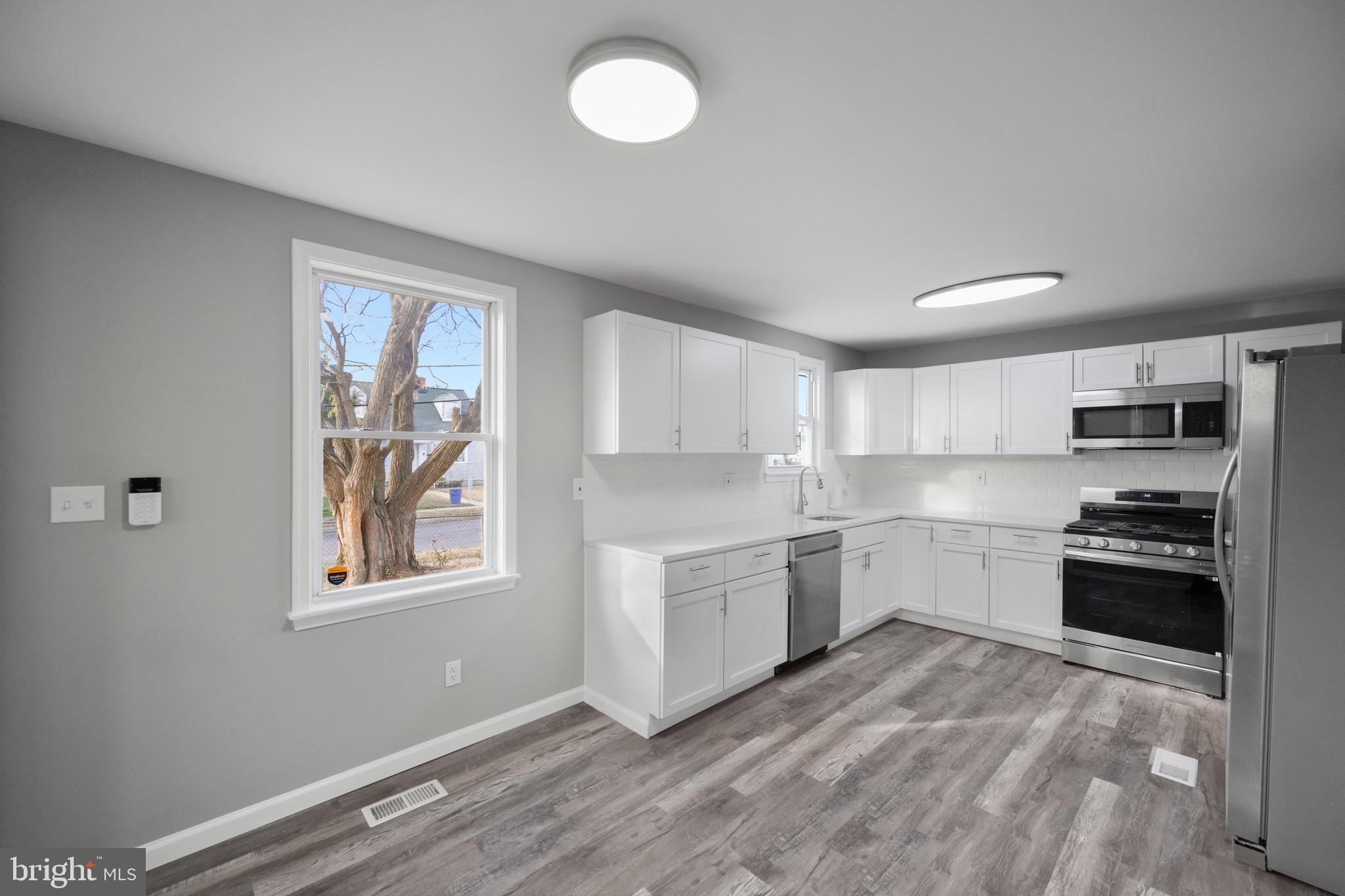 3401 Court Way Baltimore, MD 21222 - Photo 31 of 35 a kitchen with stainless steel appliances granite countertop a stove and a refrigerator