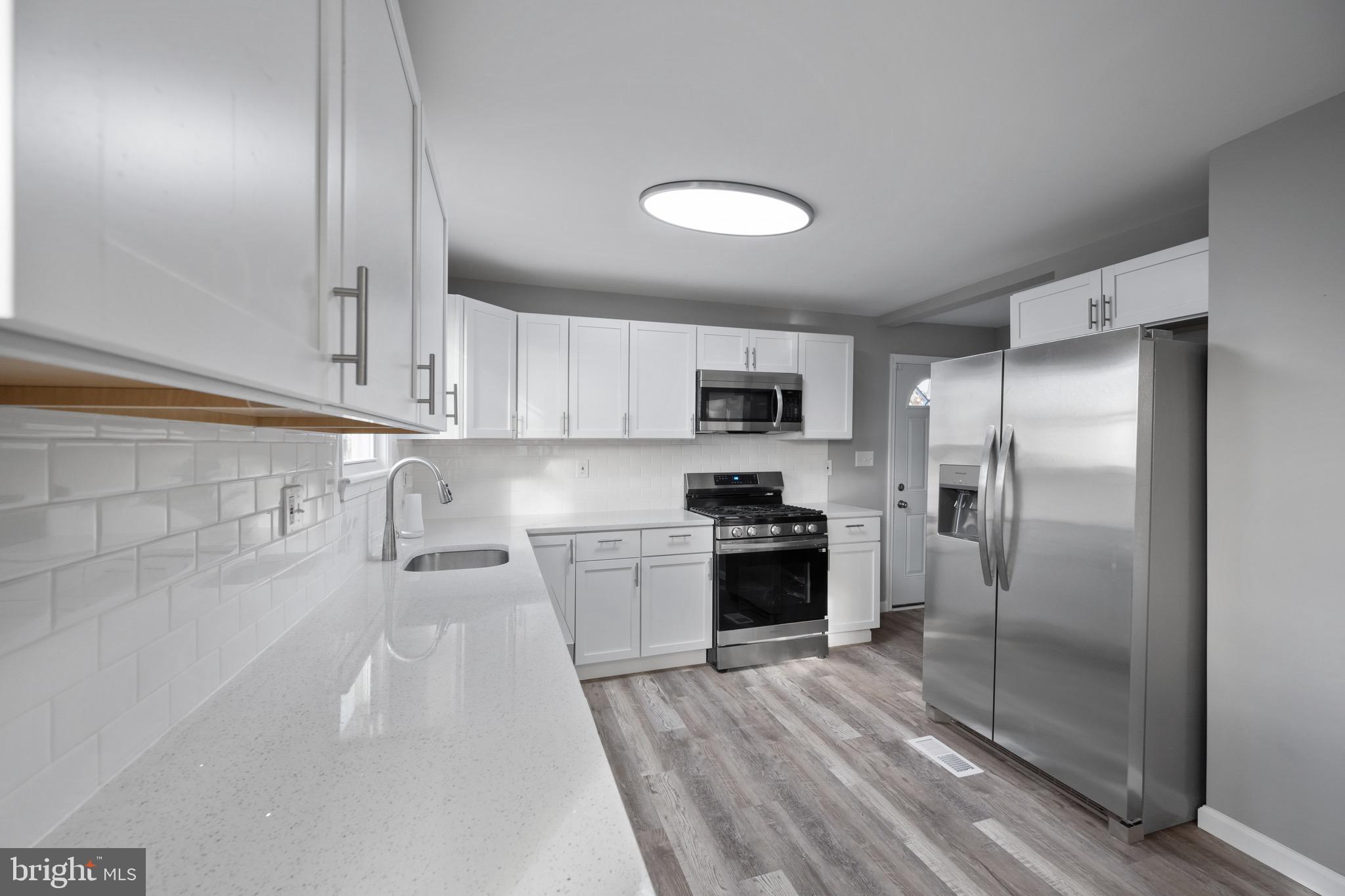 3401 Court Way Baltimore, MD 21222 - Photo 35 of 35 a kitchen with stainless steel appliances granite countertop a refrigerator a stove and a sink