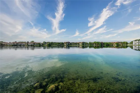 a kitchen with stainless steel appliances granite countertop a refrigerator a stove top oven a sink and dishwasher