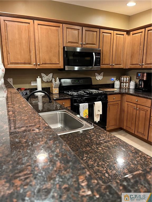 368 Rector Street, Unit 304 Perth Amboy, NJ 08861 - Photo 11 of 23 a kitchen with stainless steel appliances granite countertop a stove a sink and a microwave