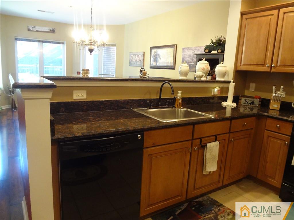 368 Rector Street, Unit 304 Perth Amboy, NJ 08861 - Photo 12 of 23 a kitchen with stainless steel appliances granite countertop a sink stove and cabinets
