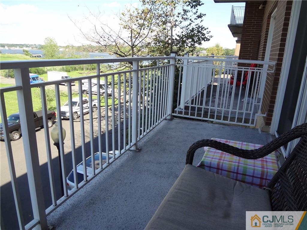 368 Rector Street, Unit 304 Perth Amboy, NJ 08861 - Photo 16 of 23 a view of balcony with wooden floor and fence