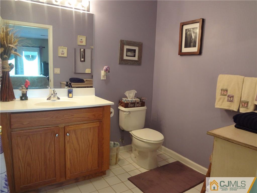368 Rector Street, Unit 304 Perth Amboy, NJ 08861 - Photo 19 of 23 a bathroom with a sink toilet and mirror