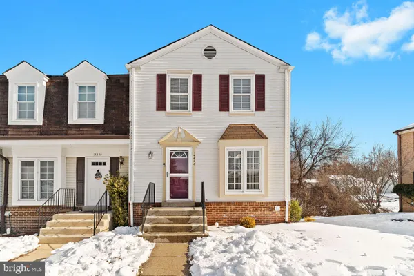 a view of a brick house with large windows