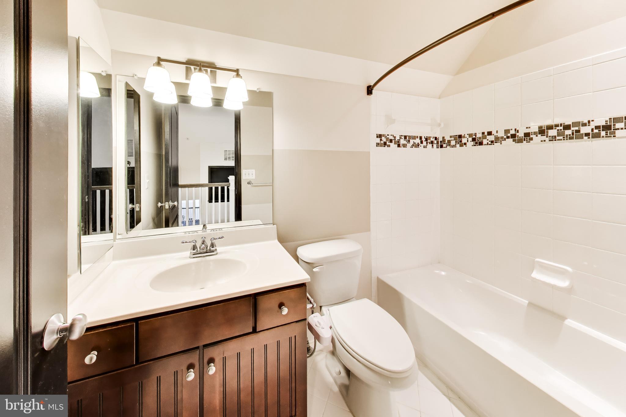 13513 Moonlight Trail Drive Silver Spring, MD 20906 - Photo 45 of 78 a bathroom with a sink a toilet a mirror and shower