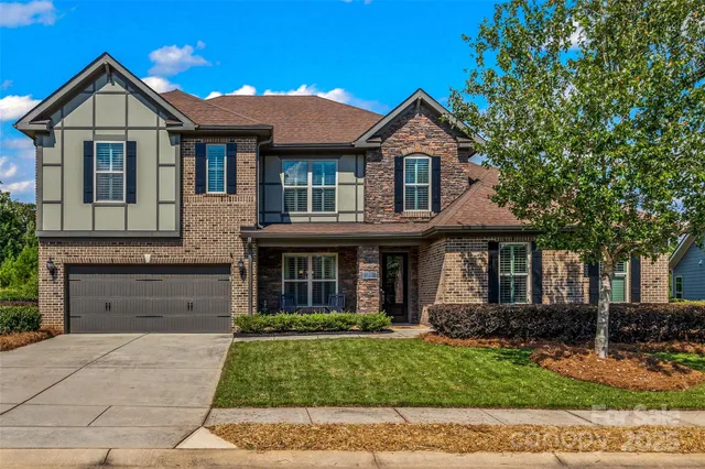 a front view of a house with a yard and garage