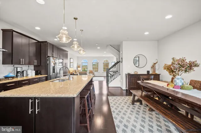 a large kitchen with lots of counter space a sink appliances and cabinets