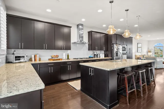 a kitchen with stainless steel appliances granite countertop wooden cabinets a sink and a stove