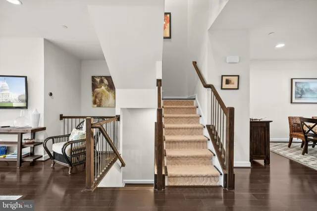 a view of entryway livingroom and hall with wooden floor