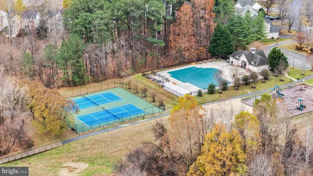 a view of a backyard with swimming pool