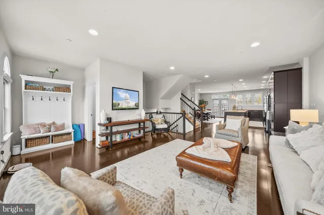 a living room with furniture and a view of kitchen