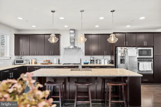 a large kitchen with a table and chairs in it