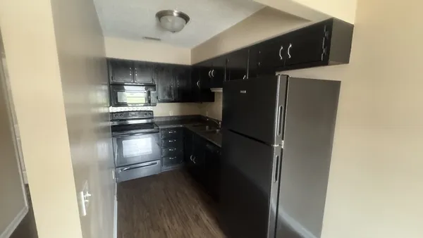 a kitchen with stainless steel appliances a refrigerator and a stove