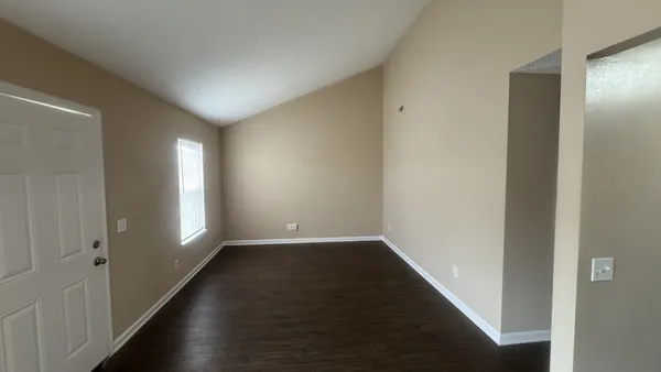 a view of hallway with window and stairs