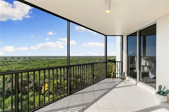 a view of a balcony with couches and city view