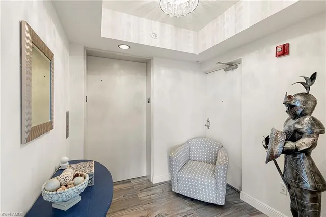 a living room with furniture a flat screen tv and a large window