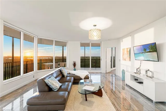 a living room with stainless steel appliances kitchen island granite countertop furniture and a kitchen view