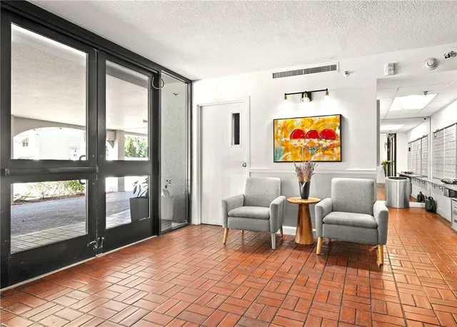 a living room with furniture and a floor to ceiling window