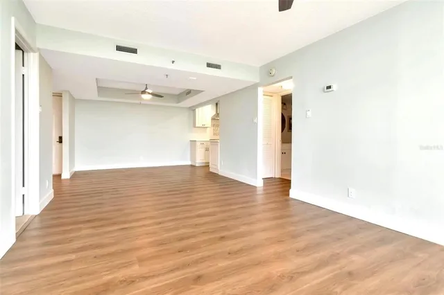 a view of an empty room with wooden floor